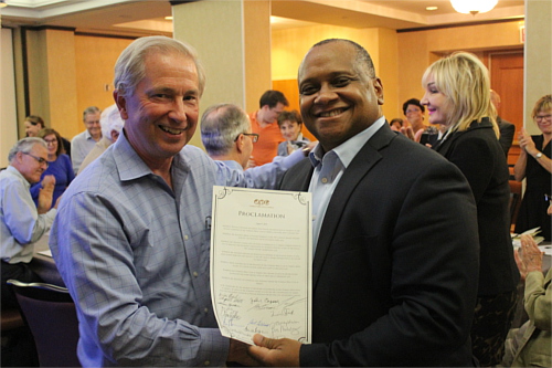 Bill Holstein, left, displays a signed proclamation in his honor with OPC President Marcus Mabry. Photo: Chad Bouhcard