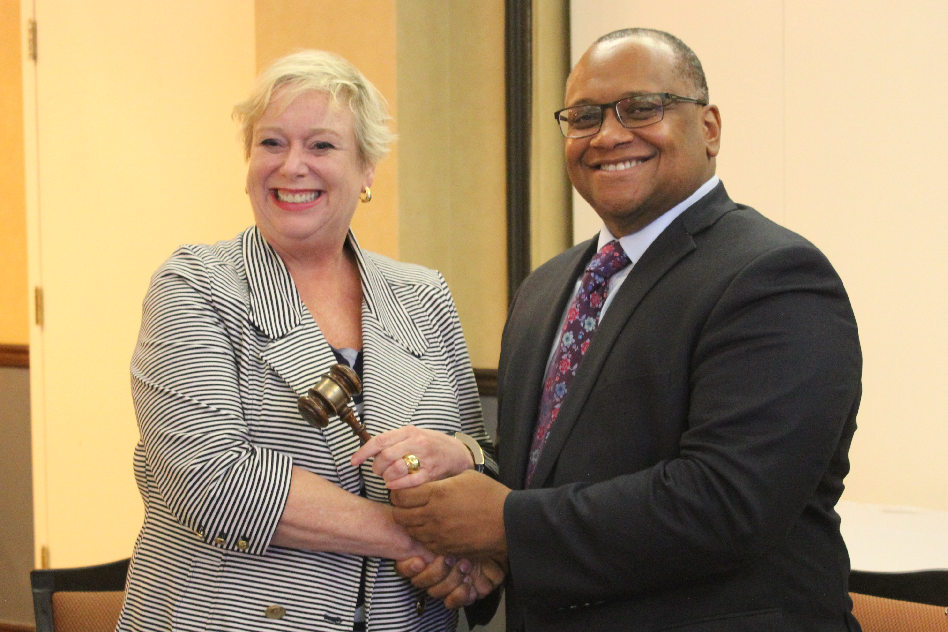 Deidre Depke, left, receives the ceremonial gavel from outgoing OPC President Marcus Mabry. Photo: Chad Bouchard